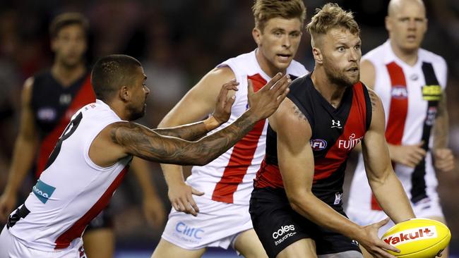 Hill attempts to tackle Essendon’s Jake Stringer during the Round 3 clash. Picture: Dylan Burns/AFL Photos via Getty Images