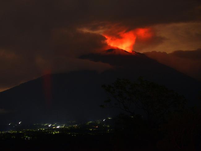 A pre-dawn view shows the erupting Mount Agung volcano. Picture: Sonny Tumbelaka