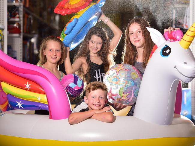 Sophia Warburton 10, Hannah Mosch 10, Willem Warburton 8 and Gemma Warburton 11 with an Intex blow up Unicorn Pool from Toyworld at Domain Central. Picture: Alix Sweeney