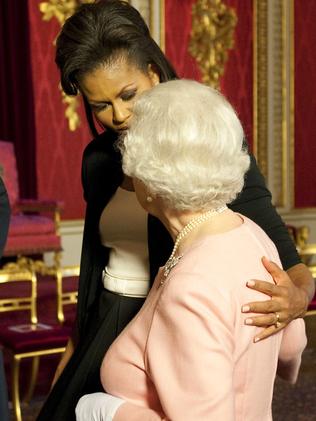Cuddling is also a royal no-no but the Queen instigated this hug with Michelle Obama in 2009. Picture: AP Photo/Daniel Hambury