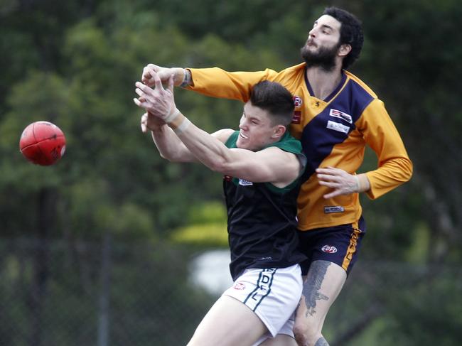 Marcus Stapleton climbs over Curtis Sanajko to spoil during his time at Strathmore. Picture: Richard Serong