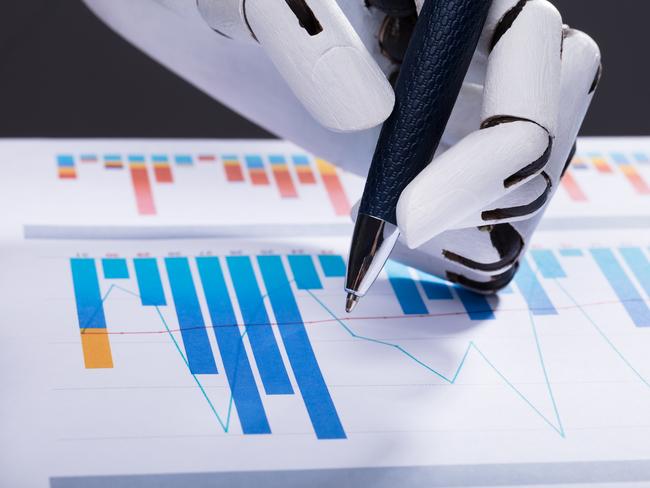 Close-up Of A Robotic Hand Using Pen While Working On Graph