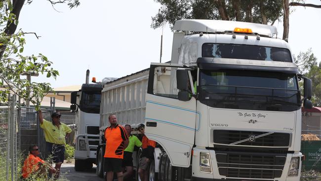 Black Swan Lake protest at Bundall goes to another level, with protesters chaining themselves to the fence and then getting themselves arrested after running onto the worksite and stopping the trucks. Police inform workmen of the situation. Picture Glenn Hampson