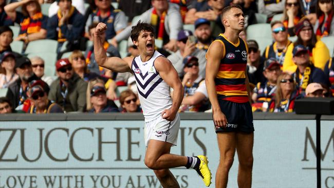 Lachie Schultz ices the game for Fremantle as Crow Lachie Sholl watches on. Picture: James Elsby/AFL Photos via Getty Images