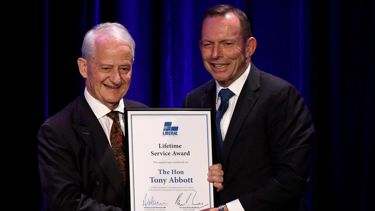 Mr Ruddock presents Mr Abbott with a Lifetime Service Award during a tribute dinner for him. Picture: AAP Image/ Bianca De Marchi)