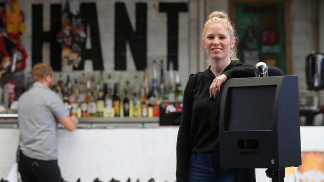 Bar manager Ashley Hooker at The Elephant Hotel with new ID scanners that the bar has had to buy for $3000 each. Picture: Adam Armstrong