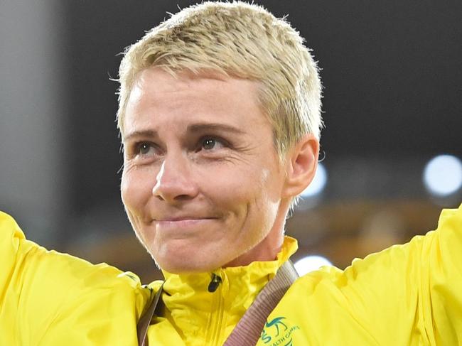 Australia's Kathryn Mitchell (C gold) poses with her medal after the athletics women's javelin throw final during the 2018 Gold Coast Commonwealth Games at the Carrara Stadium on the Gold Coast on April 11, 2018. / AFP PHOTO / SAEED KHAN