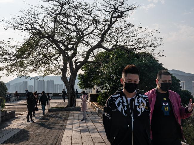 People wearing face masks walk at Monte Fort Park in Maccau on January 28, 2020. Photo: Anthony Kwan/Getty Images.