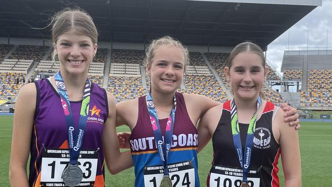 Jaida Burgoyne, middle, flanked by Jada McCoombes, right, and second placed Makayla Elcoate at QRSS championships in October.