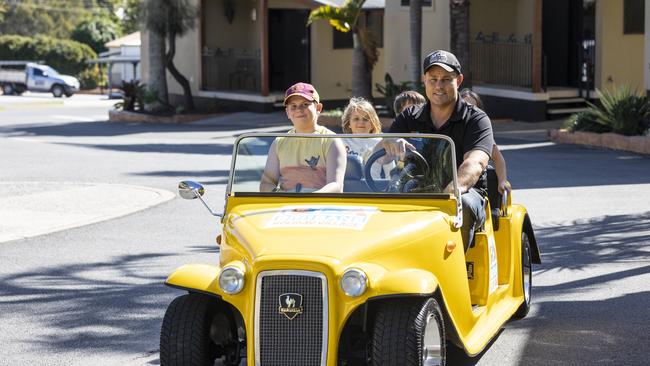 Brisbane Holiday Village general manager, Geoff Illich, takes the Burgess kids for a ride around the holiday park. Picture: Matthew Poon.