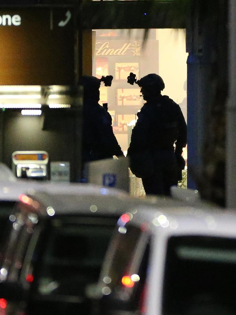 Two armed tactical response officers stand ready to enter the Lindt cafe. Picture: Glenn Nicholls (AP)