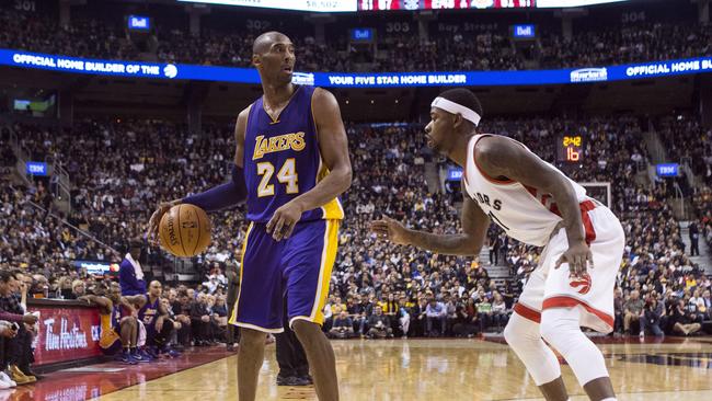 Los Angeles Lakers' Kobe Bryant, left, looks to make a play as Toronto Raptors' Terrence Ross covers during second half.