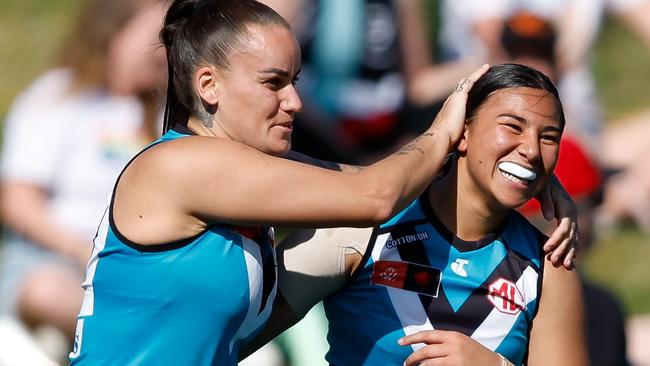 Gemma Houghton congratulates Hannah Ewings on her miracle goal from the boundary. Picture: Dylan Burns/AFL Photos via Getty Images