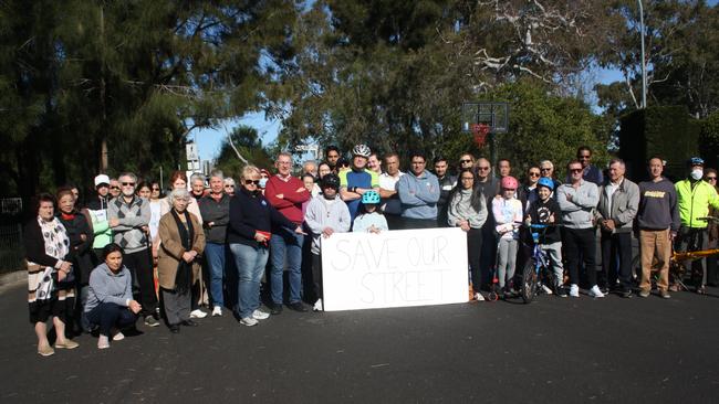 Residents of Marceau Drive, alongside Councillor Andrew Ferguson (centre-left) and Reid federal MP Sally Sitou (centre-right) converge to voice their disapproval of and fears about the through road plans. Picture: Alexi Demetriadi