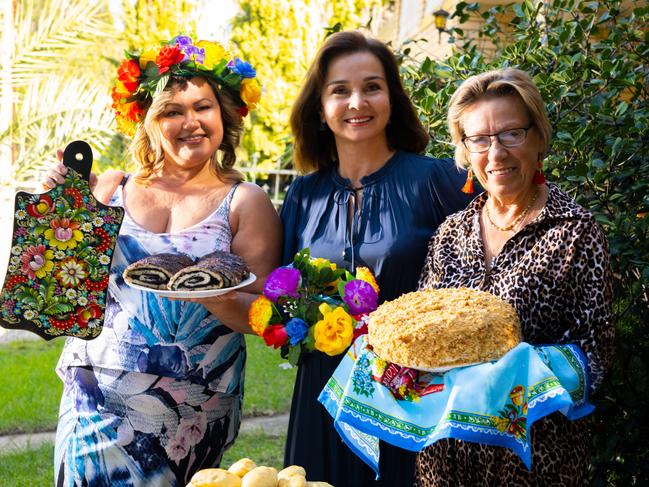 Olga Papageorgakis, Dilara Valiff and Natalia Atkins with traditional desserts Apple Pirozhki, Poppyseed Roulette and Medovik. They are baking for an Easter fare, to raise money for Ukranian refugees in Adelaide/ Kaurna Yerta on Friday, April 8, 2022. (The Advertiser/ Morgan Sette)