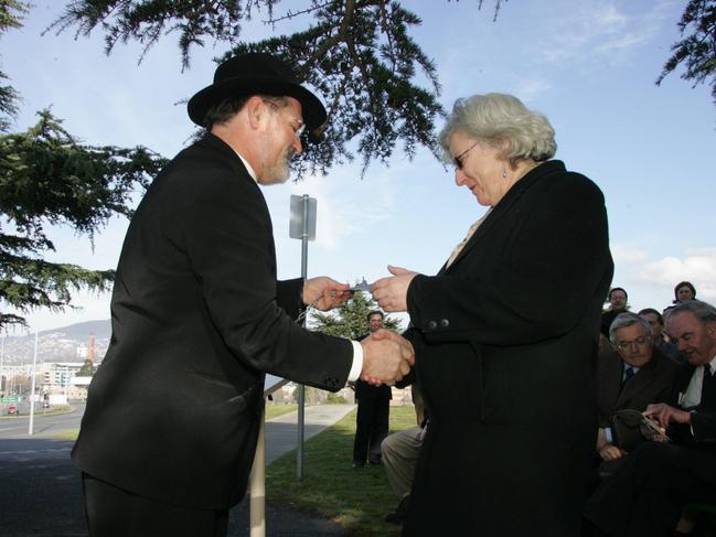 The then Lord Mayor of Hobart, Rob Valentine, shows Margaretta Pos the original plaque for the tree commemorating her grandfather, Oliver Page, on the Soldiers Memorial Avenue on the Queens Domain in Hobart. Picture: KIM EISZELE