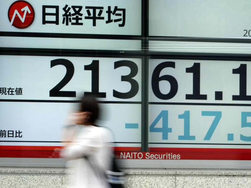 A woman walks past an electronic stock board showing Japan's Nikkei 225 index at a securities firm in Tokyo Thursday, Oct. 3, 2019. Picture: AP Photo/Eugene Hoshiko