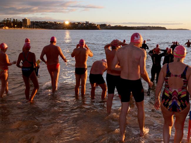 Manly's Bold and Beautiful swimming squad going out for their early morning winter swim. Picture: Annika Enderborg