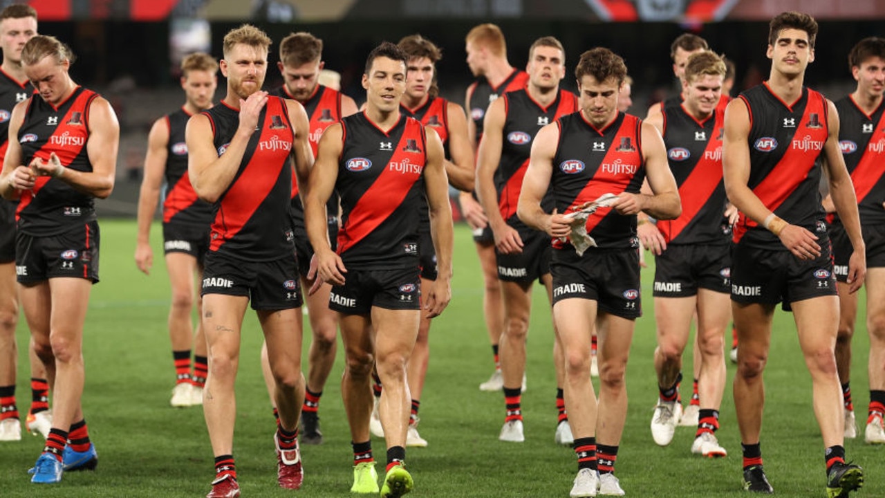 MELBOURNE, AUSTRALIA - APRIL 17: The Bombers walk off after they were defeated by the Dockers during the round five AFL match between the Essendon Bombers and the Fremantle Dockers at Marvel Stadium on April 17, 2022 in Melbourne, Australia. (Photo by Robert Cianflone/Getty Images)