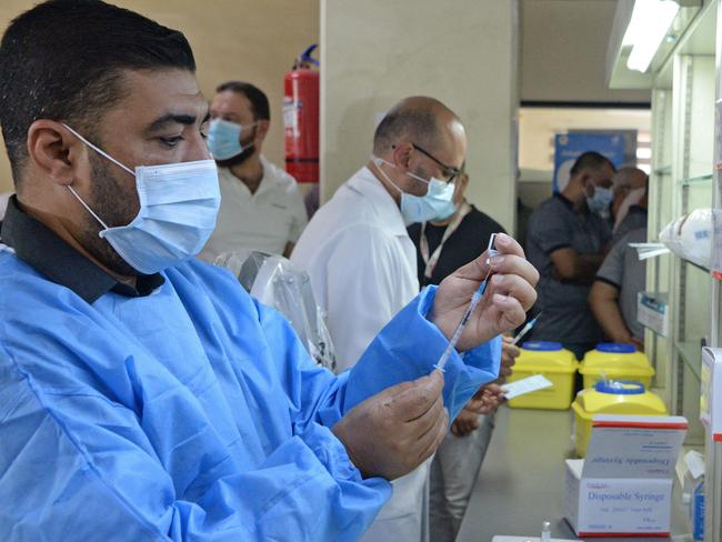 Iraqi health workers prepare doses of the Pfizer vaccine at al-Salam hospital in Mosul. Picture: AFP