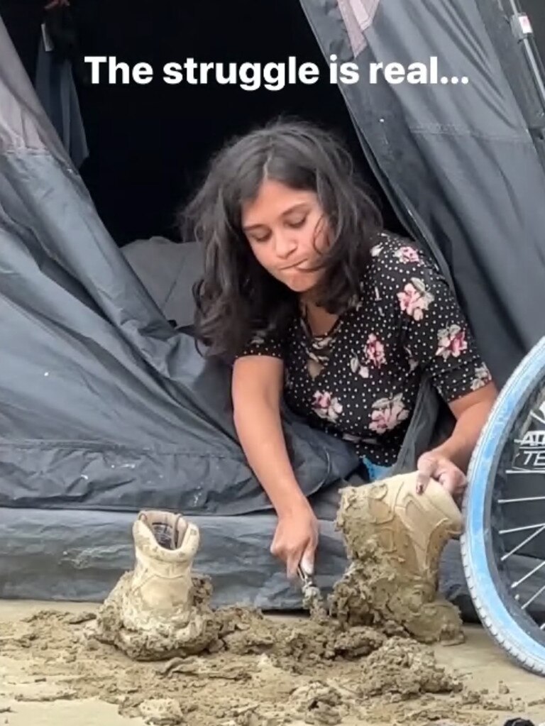 Camper tries to clean mud from her boots. Picture: Instagram.