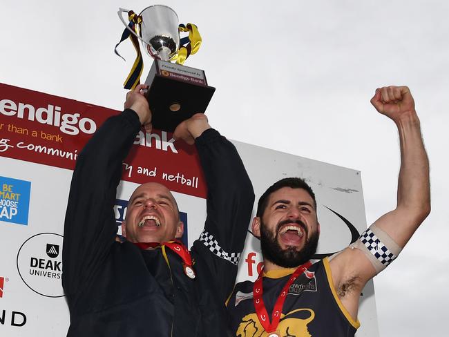 Steve Buckle and Nick Batsanis lift the premiership cup. Picture: James Ross/AAP