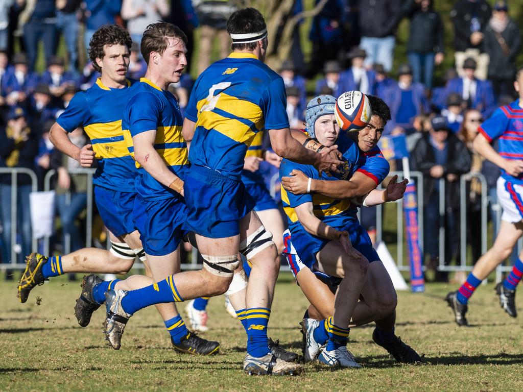 Grammar's Richard Dean gets a pass away to George Griffiths against Downlands in O'Callaghan Cup on Grammar Downlands Day at Downlands College, Saturday, August 6, 2022. Picture: Kevin Farmer