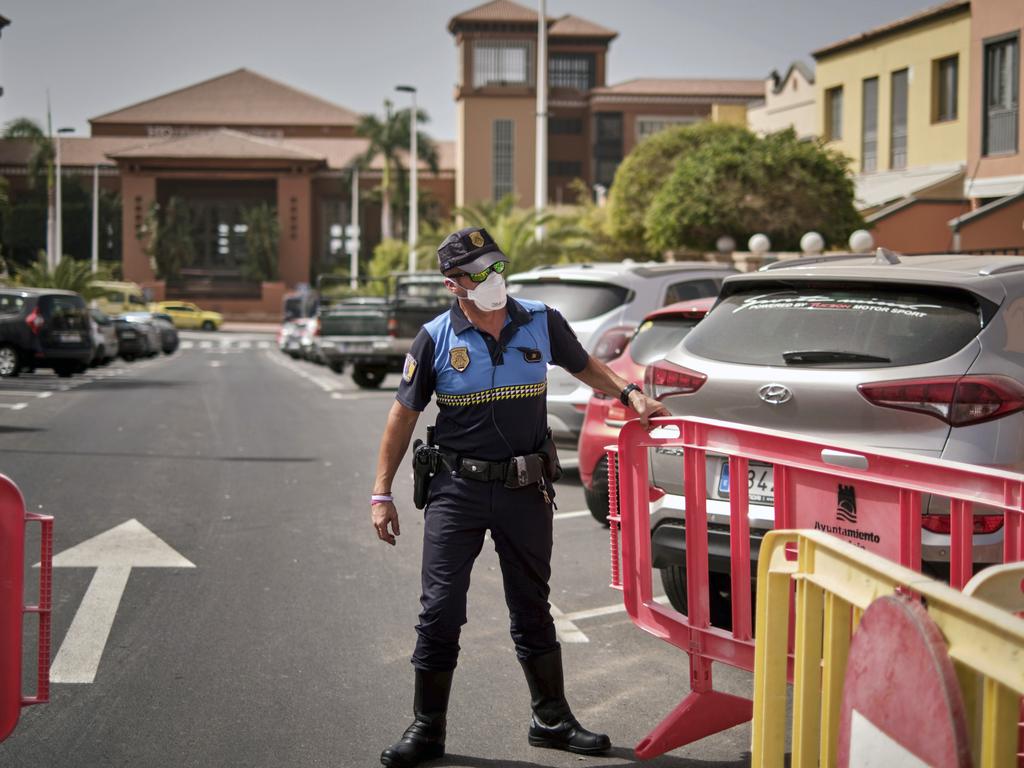 A Spanish police officer sets a barrier blocking the access to the hotel. Picture: AP