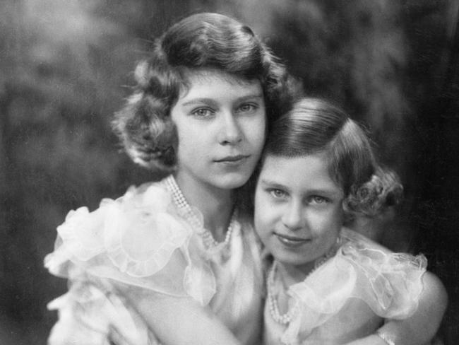 Princess Elizabeth posed with her sister Princess Margaret, aged 9, for her 14th birthday.