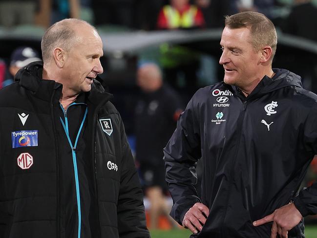 ADELAIDE, AUSTRALIA - MAY 30: Ken Hinkley, Senior Coach of the Power talks to Michael Voss, Senior Coach of the Blues during the 2024 AFL Round 12 match between the Port Adelaide Power and the Carlton Blues at Adelaide Oval on May 30, 2024 in Adelaide, Australia. (Photo by James Elsby/AFL Photos via Getty Images)