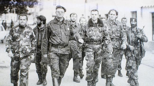  Zoran Tadic (far left) walking with Vojislav Seselj (wearing beret), a Serbian politician sentenced for war crimes at The Hague Tribunal, with other members of his brigade. Picture: Supplied.