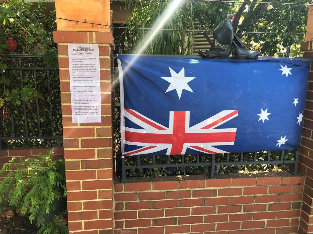 The family’s note, inverted flag and boots, in protest of Western Australia’s lockdown. Picture: Bell Tower Times