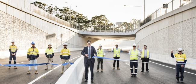 State Liberal MP for Davidson, Jonathan O'Dea, along with road construction workers, cuts the ribbon on the Warringah Rd underpass at Frenchs Forest, part of the $500 million upgrade to the road network around Northern Beaches Hospital. Picture: Transport for NSW