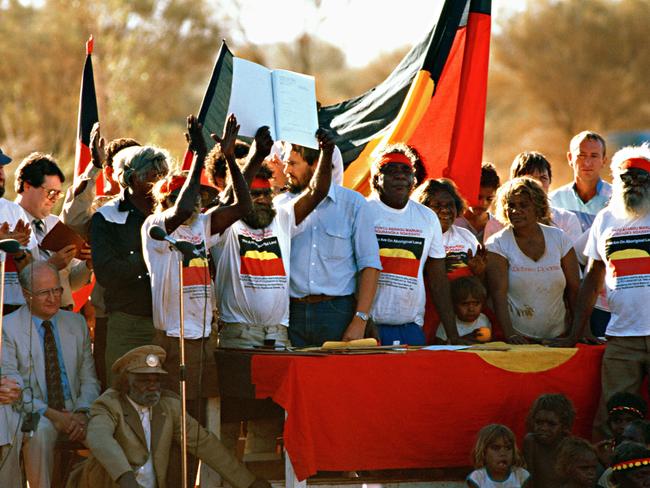 EMBARGOED 00.01PM 1ST JAN 2013. the Hawke years, from the National Archives, to go with embargoed stories on Cabinet records (this year from 1984/85 Hawke years) that are released on New Years Day. Celebrations at the ceremony to return Uluru to the traditional Indigenous owners in 1985. Governor-General, Sir Ninian Stephen and Minister for Aboriginal Affairs, Clyde Holding, are seated at left.