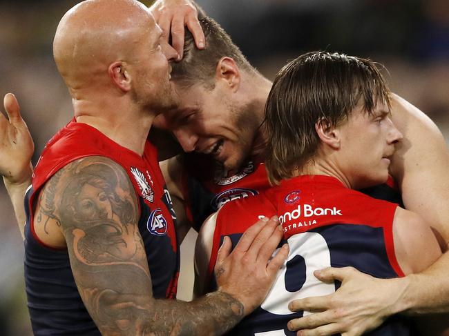 MELBOURNE, AUSTRALIA - APRIL 24: Tom McDonald of the Demons celebrates a goal with Nathan Jones of the Demons and Charlie Spargo of the Demons during the 2021 AFL Round 06 match between the Melbourne Demons and the Richmond Tigers at the Melbourne Cricket Ground on April 24, 2021 in Melbourne, Australia. (Photo by Dylan Burns/AFL Photos via Getty Images)