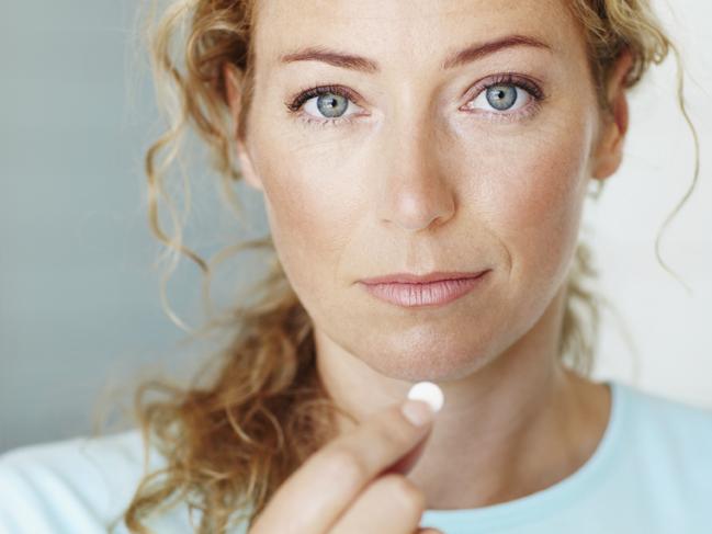 Generic photo of a woman taking a tablet / medicine. Picture: iStock