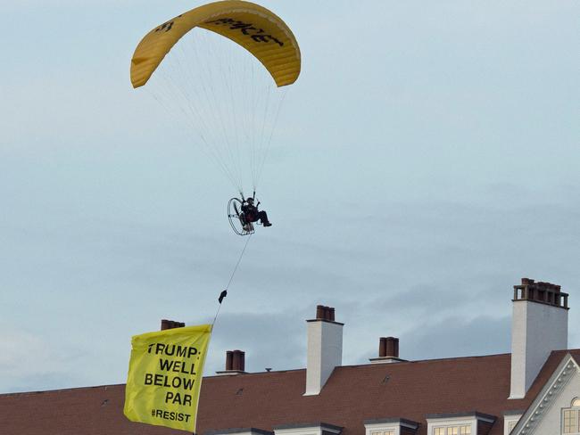 In this Friday, July 13, 2018 photo, a Greenpeace protester flying a microlight passes over US President's Donald Trump's resort in Turnberry, Scotland. Picture: AP