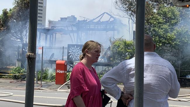 Bystanders at Cafe Topiary in Rawson St Epping, which burned down just after 1pm today.