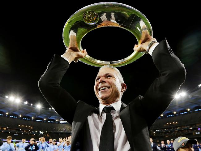 Steve Corica holds the winner’s trophy aloft for travelling fans in Perth.