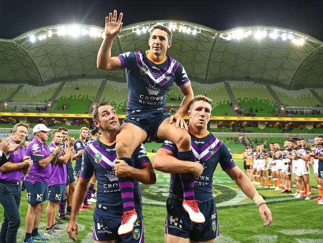 Cam Smith and Ryan Hoffman chair Billy Slater off the field. Picture: Getty