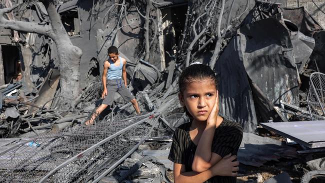 A girl stands by the rubble outside a building that was hit by Israeli bombardment in Rafah in the southern Gaza Strip. Picture: AFP