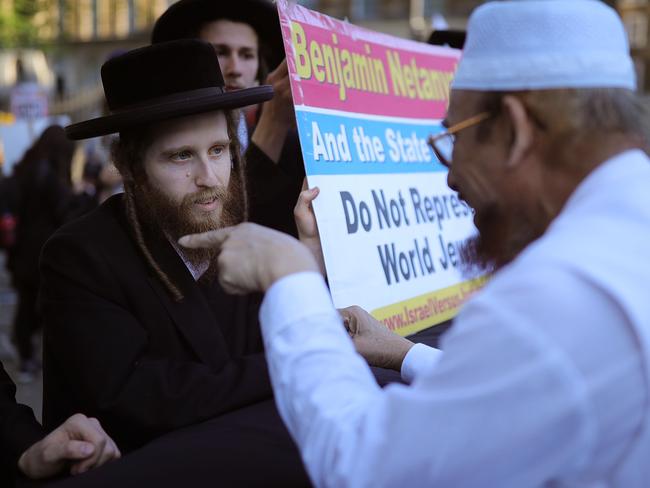 An Orthodox Jew and a Muslim take part in friendly debate during a protest against Israel in London. Picture: Christopher Furlong/Getty Images