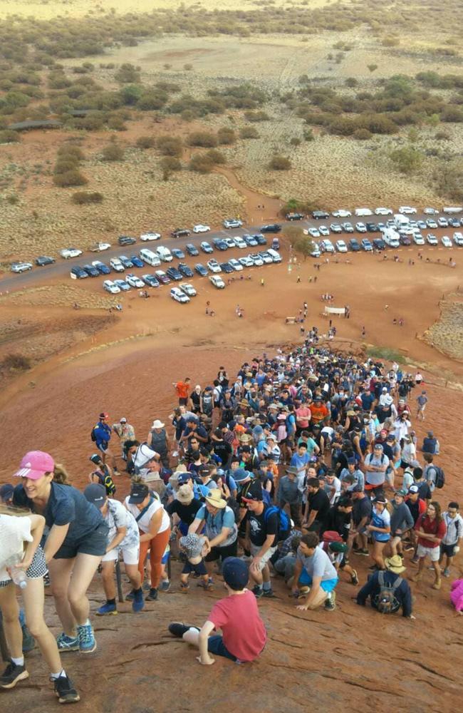 Crowds attempting to climb Uluru ahead of a ban and against the advice of traditional owners.