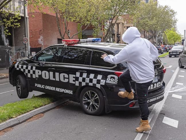 A protester kicks a police vehicle during the construction worker march. Picture: Jason Edwards