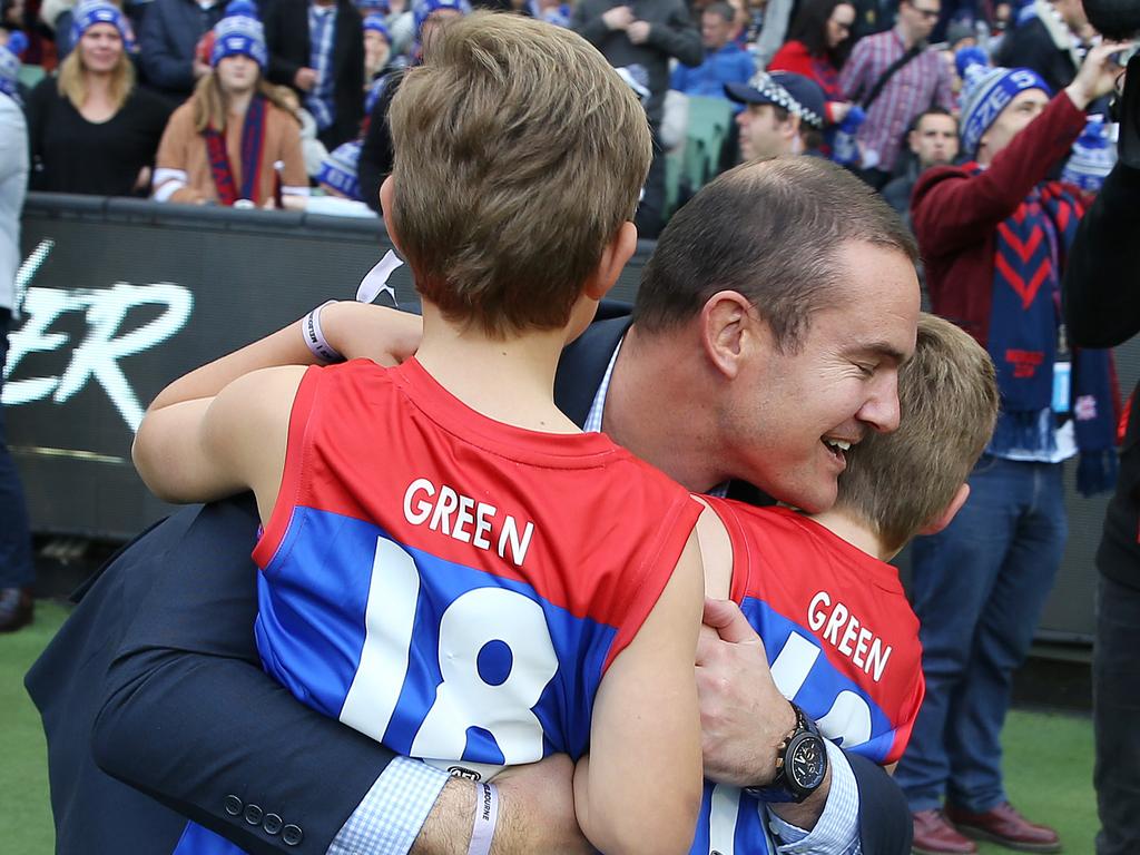 The family embrace on the side of the MCG.