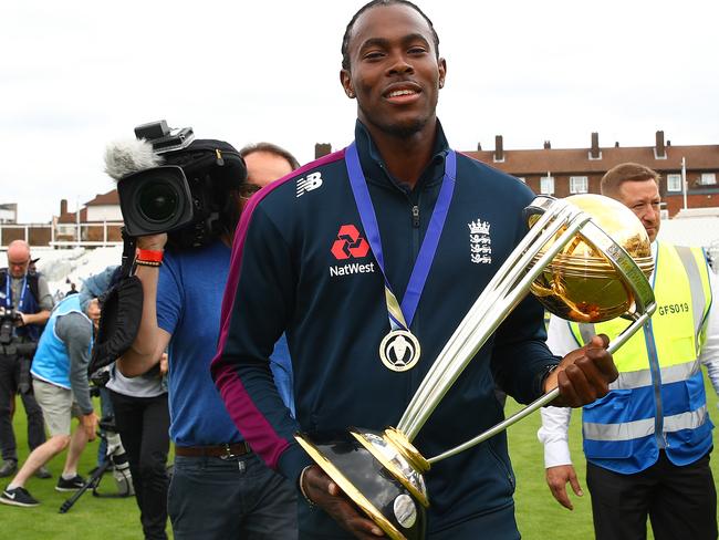 Jofra Archer poses for a photo with the Cricket World Cup trophy.