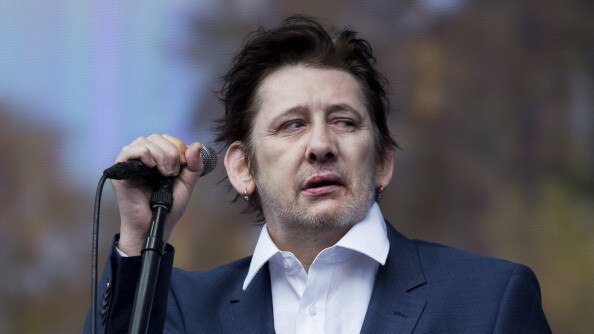 Shane MacGowan of The Pogues performs on stage in 2014. (Photo by Tristan Fewings/Getty Images)