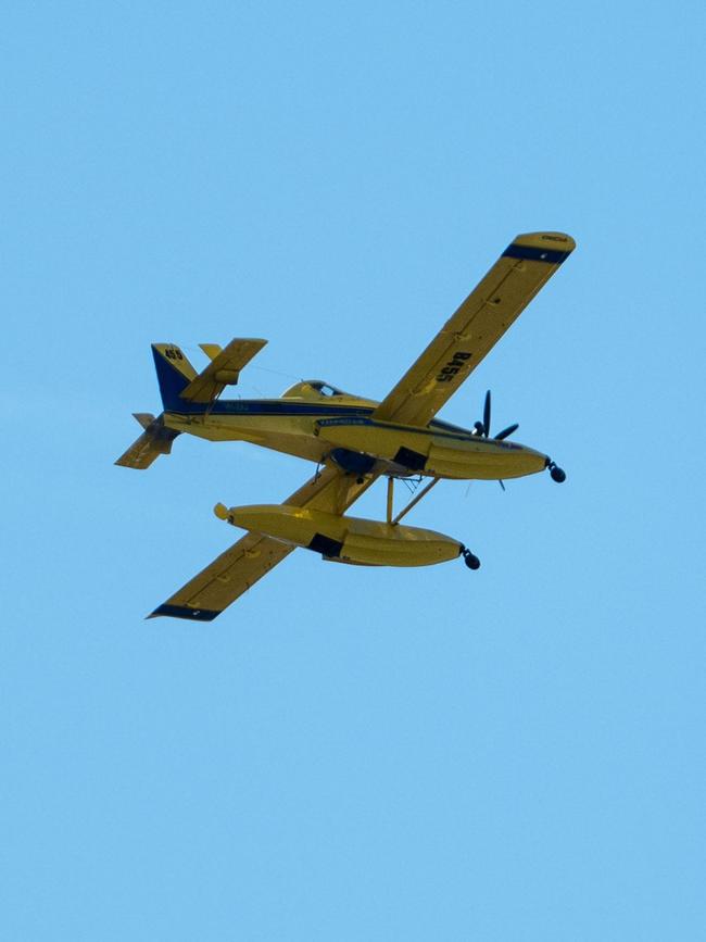 Multiple units from the Tasmanian Fire Service and Tasmania Police battled a large grass fire at Herdsmans Cove and spot fires at Bridgewater, with water bombing aircraft dousing the flames. Photo: Rory Jones