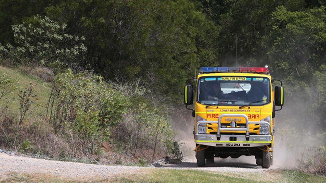 Rural Fire Brigade members keep an eye on a fire in Lower Beechmont. Picture: Glenn Hampson.