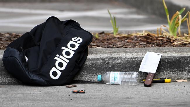 A backpack and knives along with scissors are seen at a shopping centre adjacent to Bonnyrigg High School. Picture: (AAP Image/Dan Himbrechts)